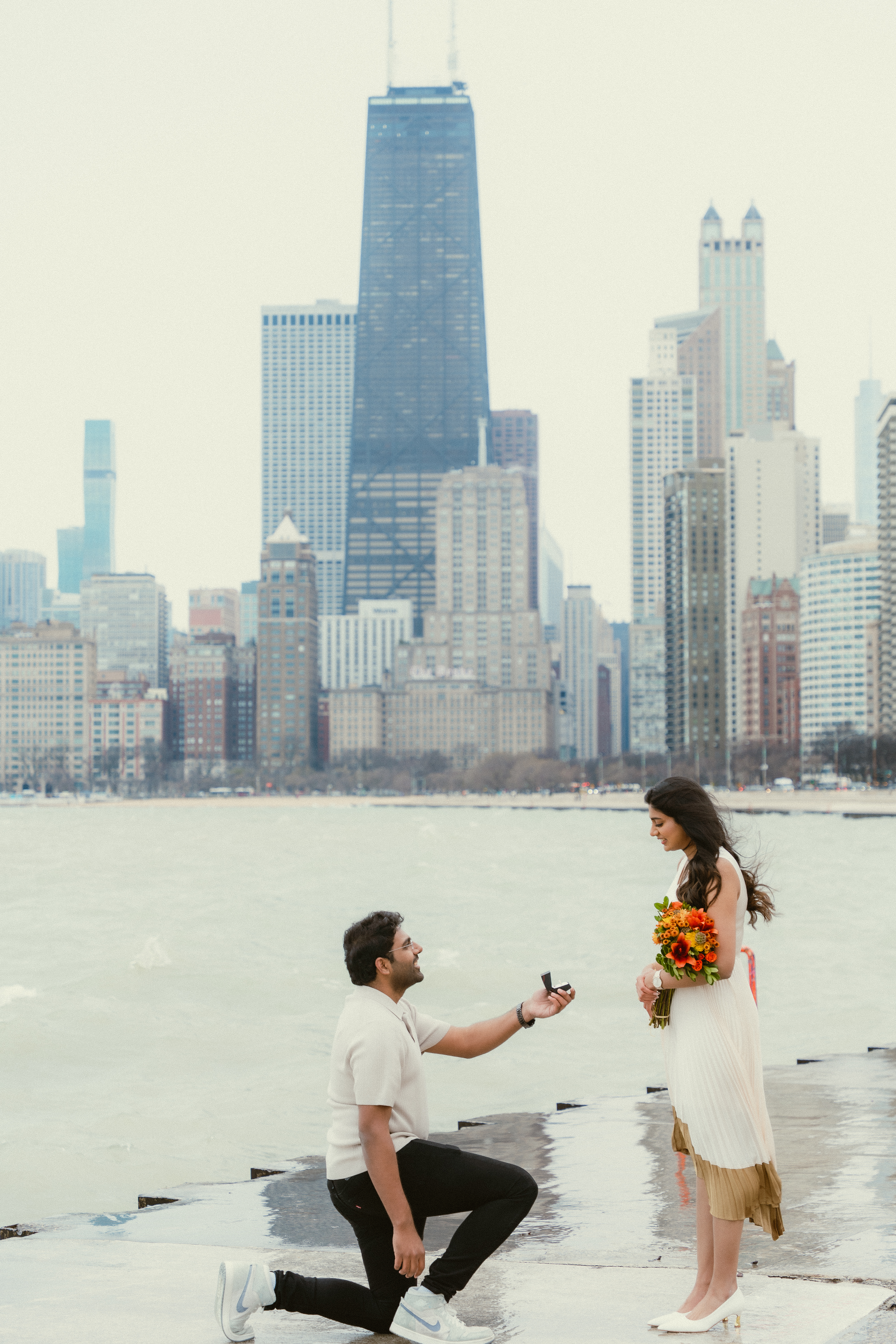 Akhila & Subhash in a cinematic couple portrait at the Chicago Riverwalk by Aakaara Studios.